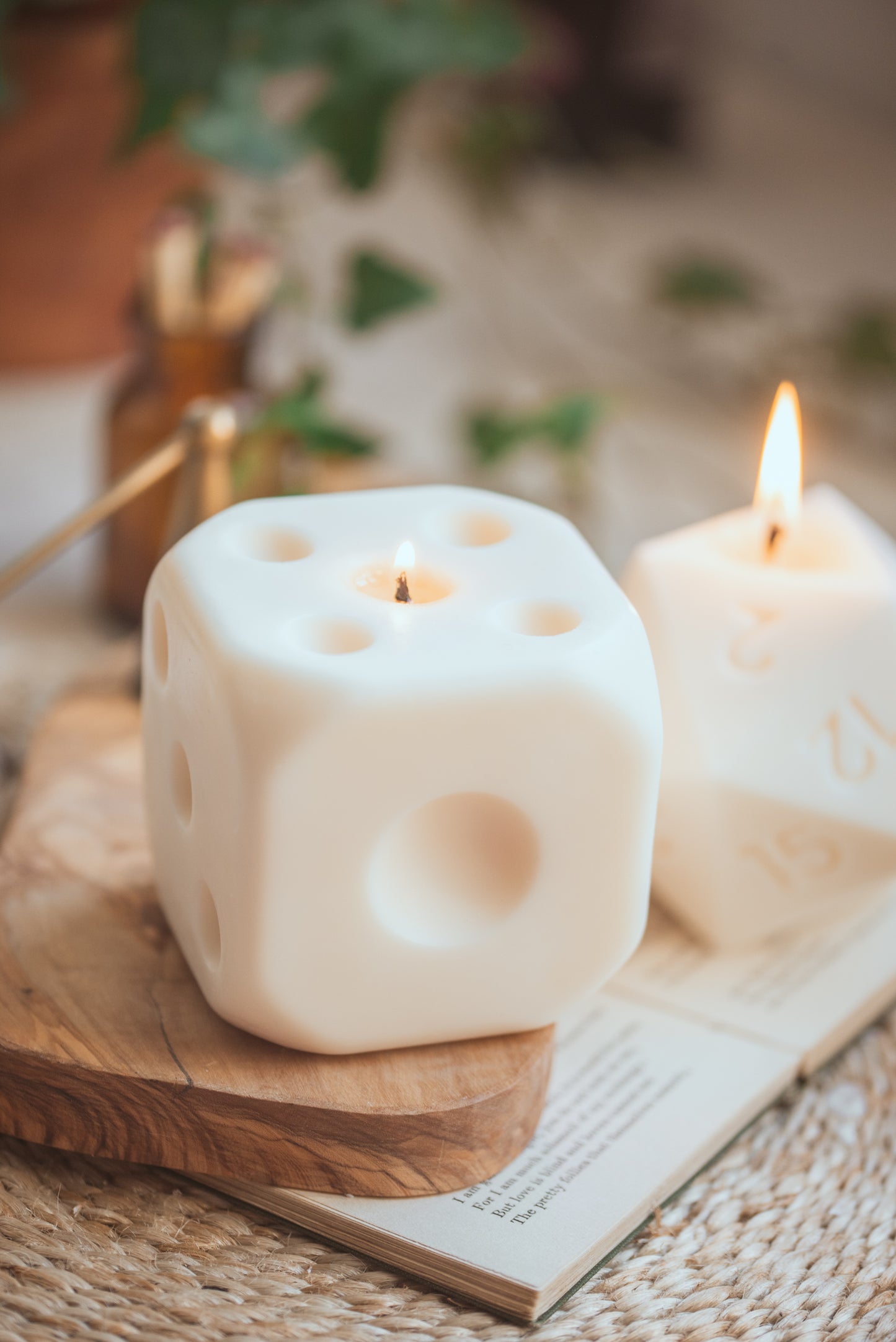 Dice D6 sculptural unscented candle lit on table