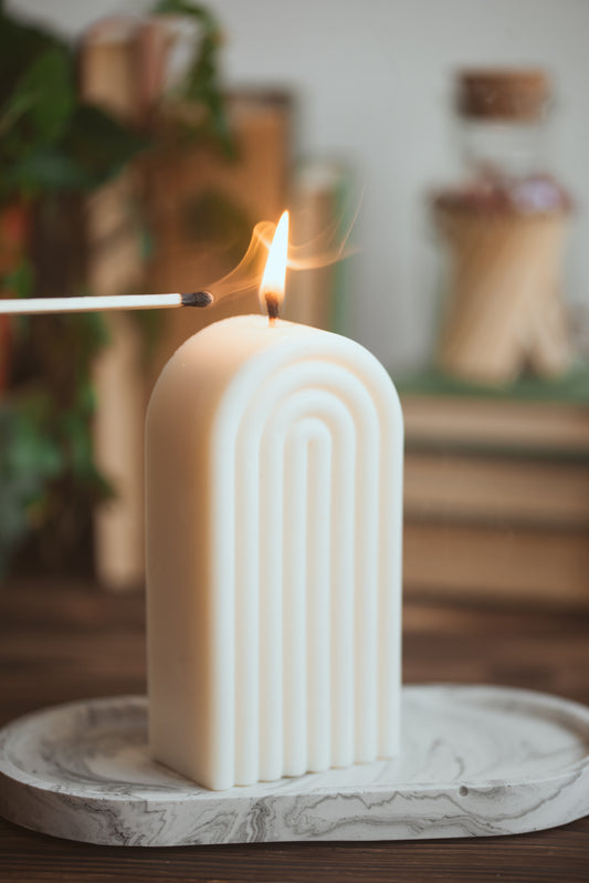 Arch rainbow-shaped soy wax candle styled on a tray