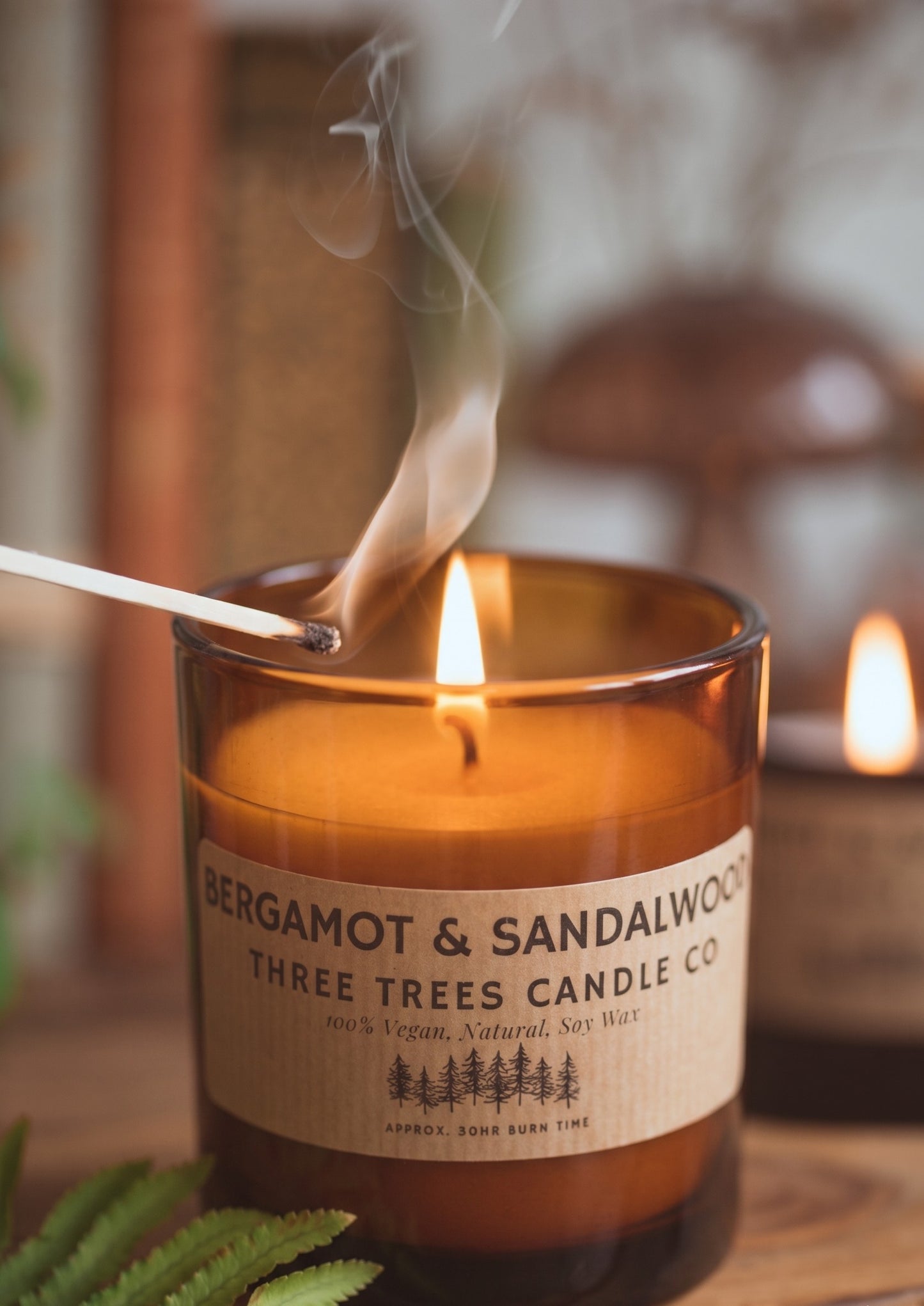 bergamot and sandalwood scented soy wax candle in amber glass