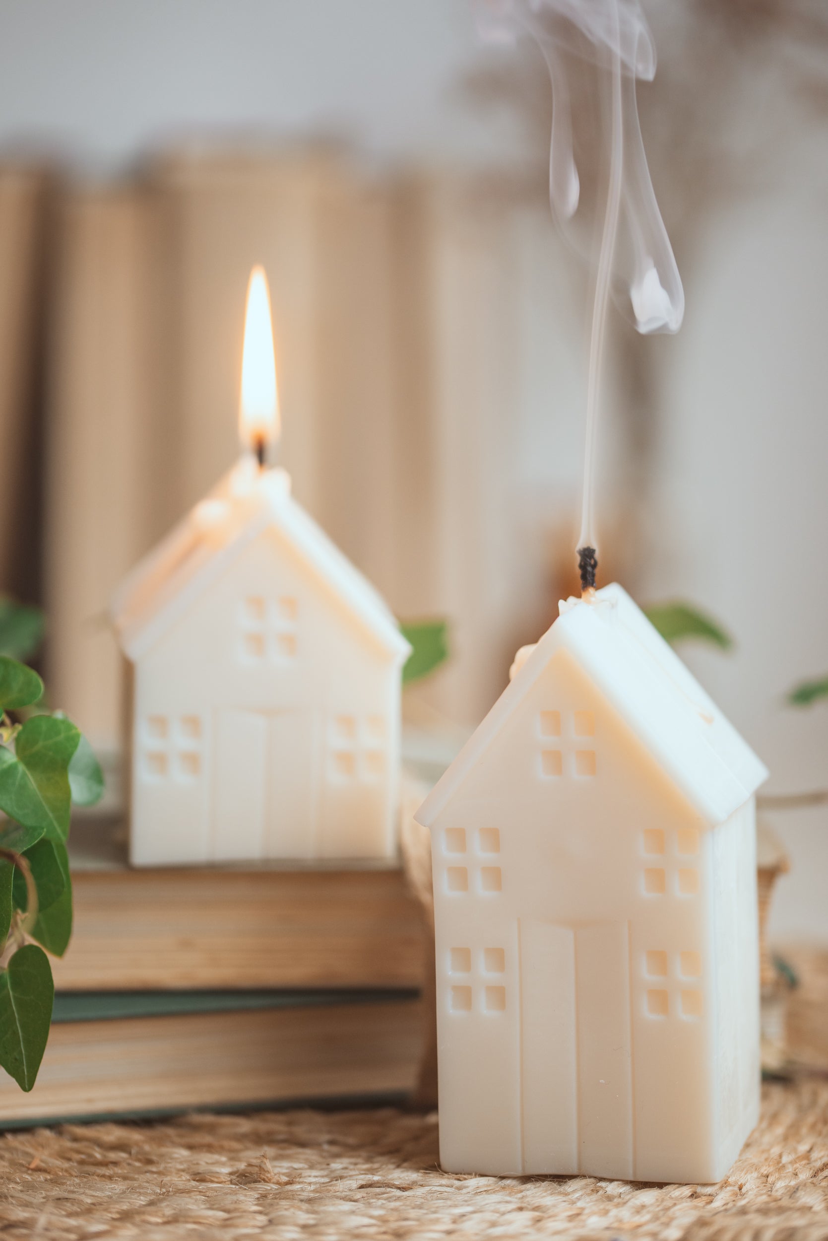 House-shaped candle styled on table as decorative home accent