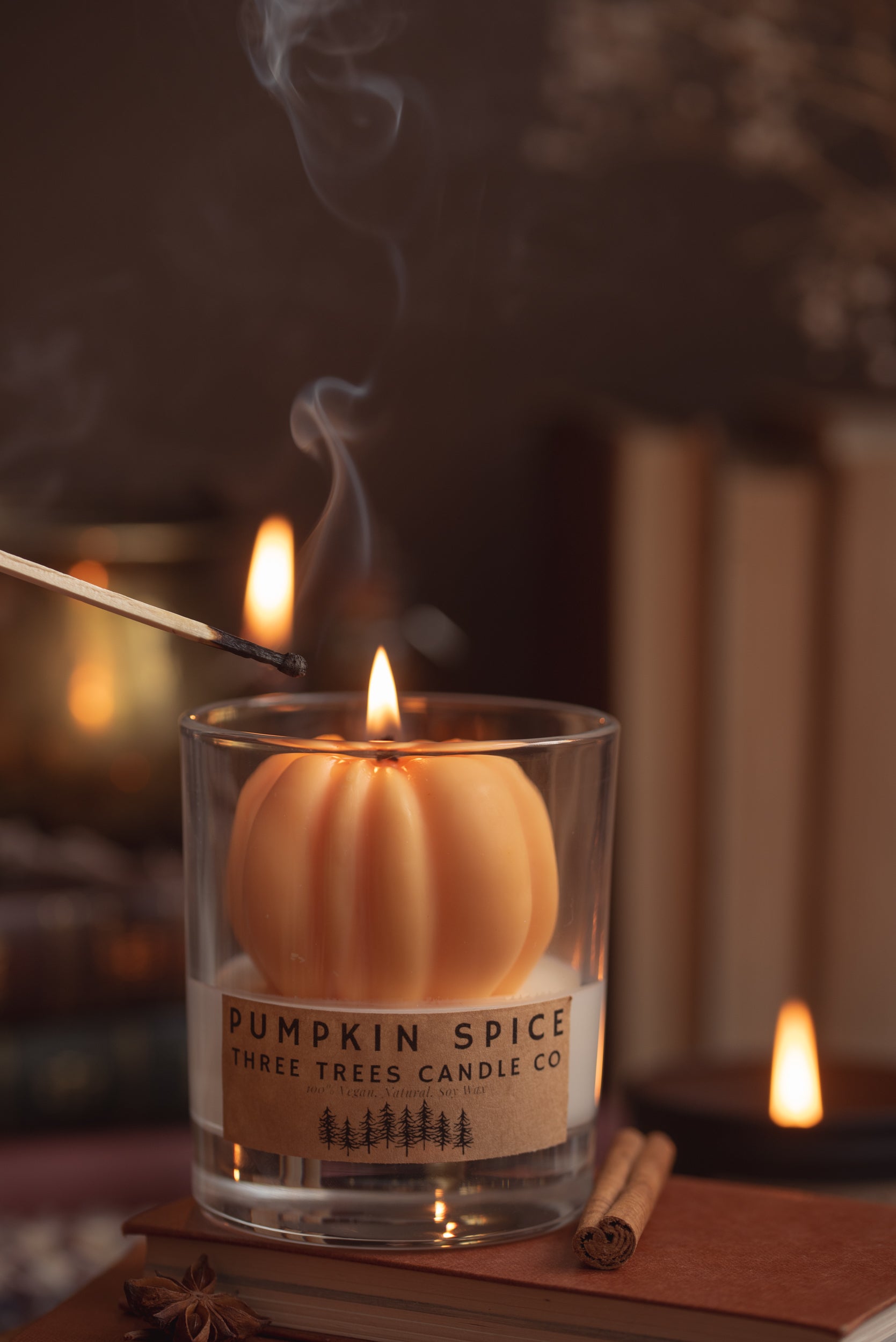 Close-up of pumpkin spice soy candle with warm orange wax