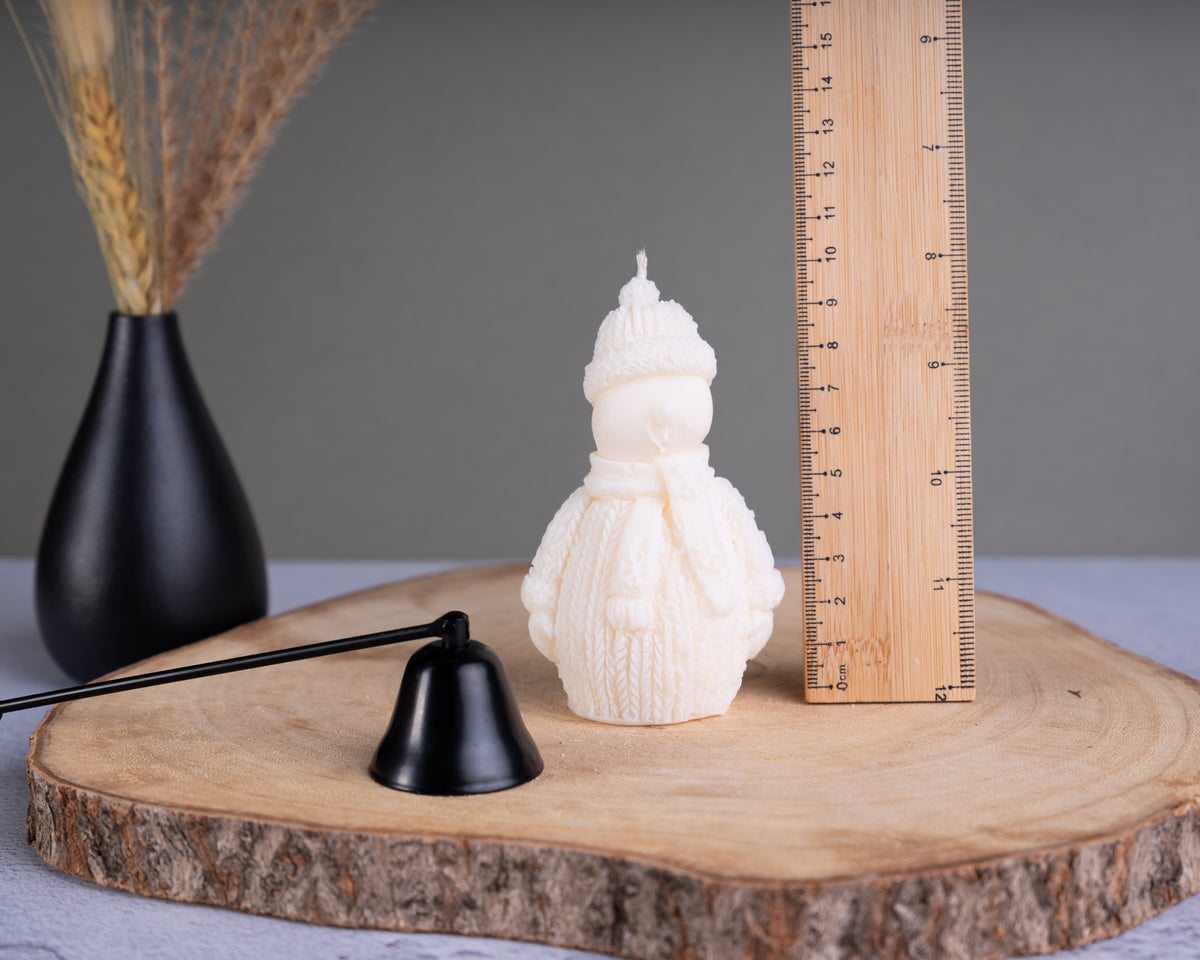 Close-up of snowman candle showing measurement