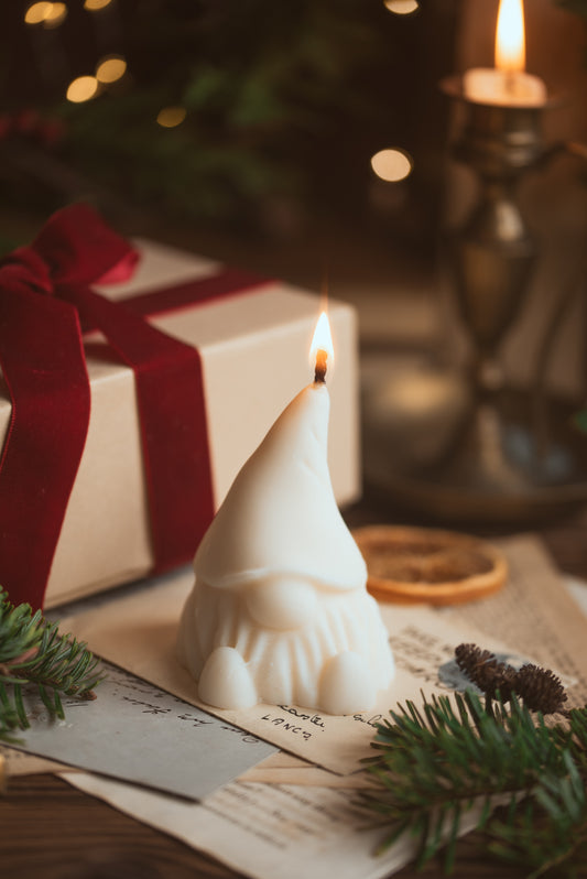 Gonk-shaped soy wax candle with festive design