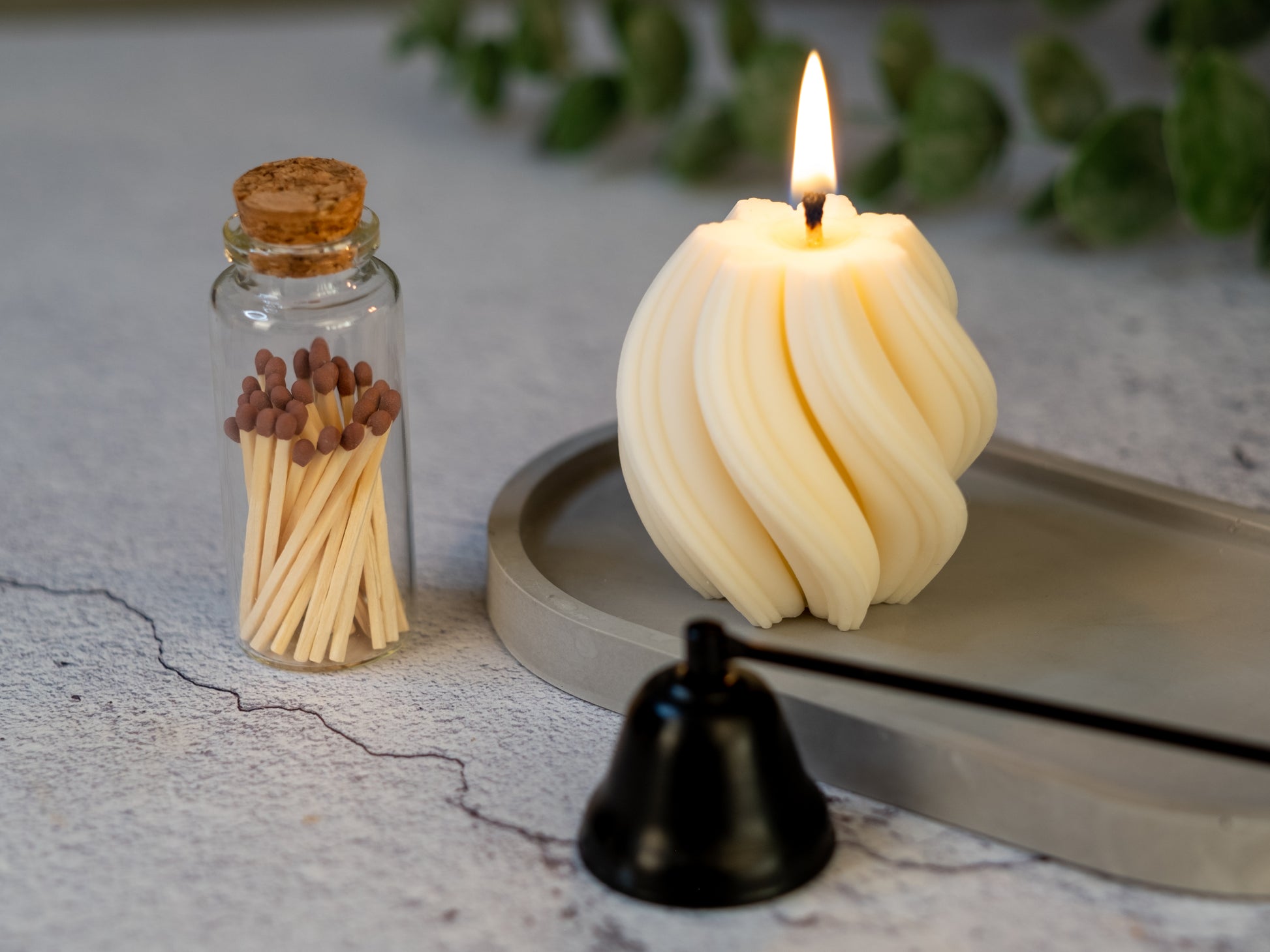 Jar of matches styled next to lit candles on table