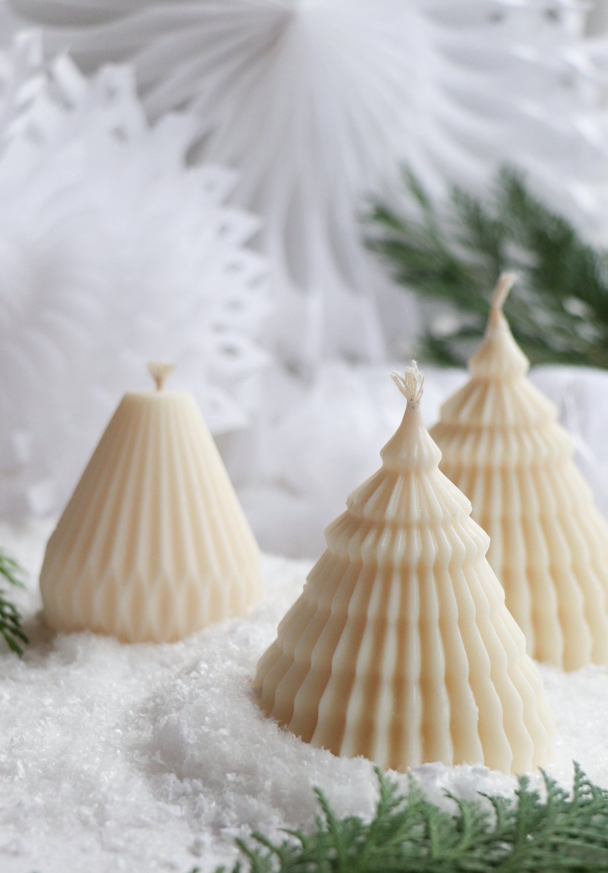 Layered Christmas tree candle styled with modern holiday decor