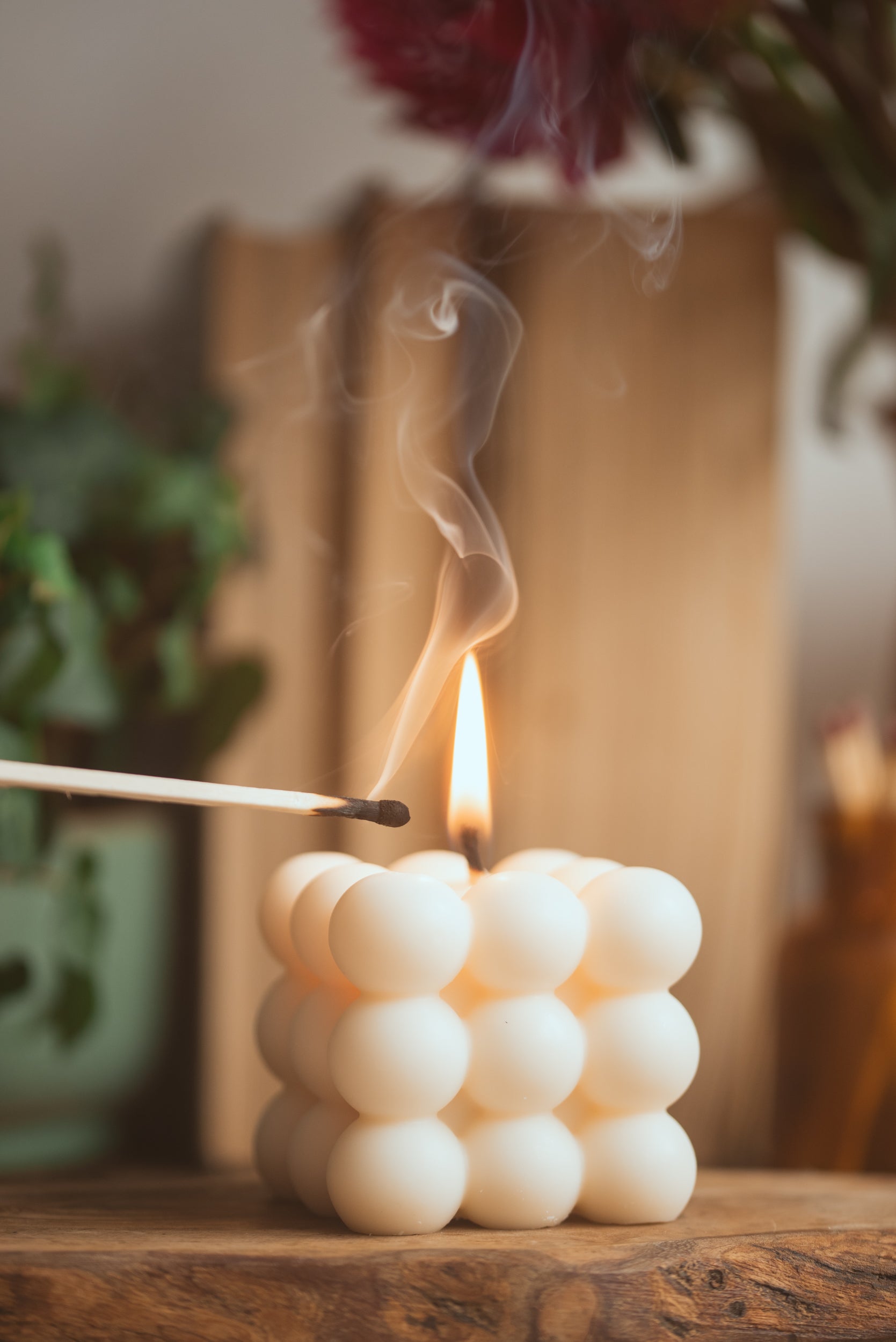 Lit bubble cube soy candle creating warm and cozy ambiance