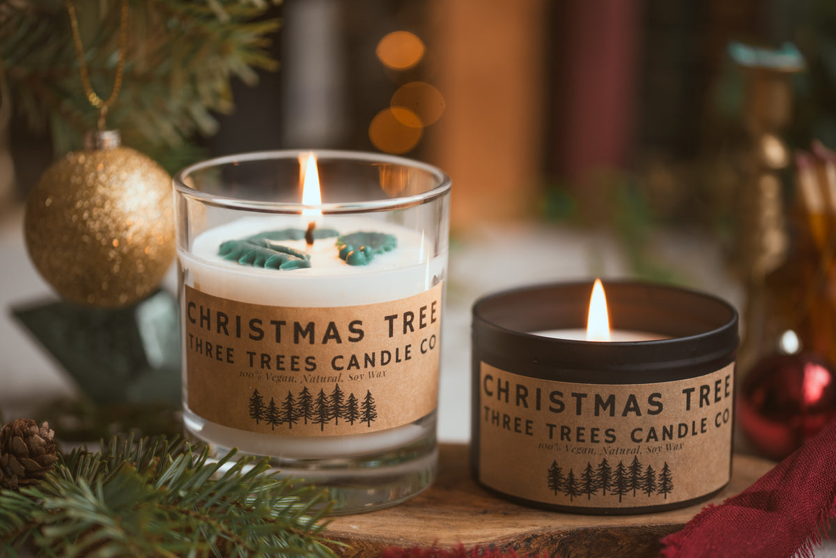 Lit Christmas tree soy candle creating cozy pine-scented atmosphere