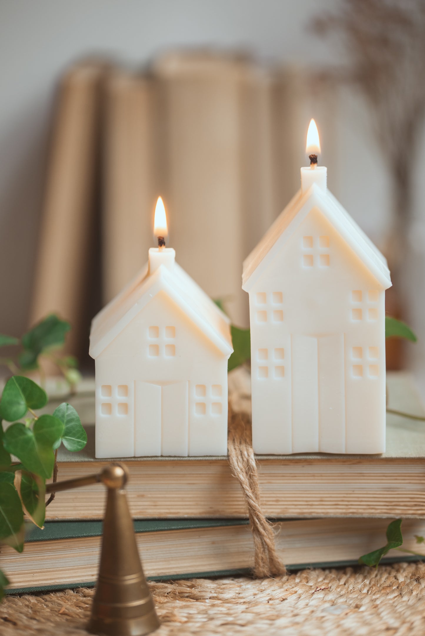 Lit house-shaped soy candle creating warm and cozy ambiance