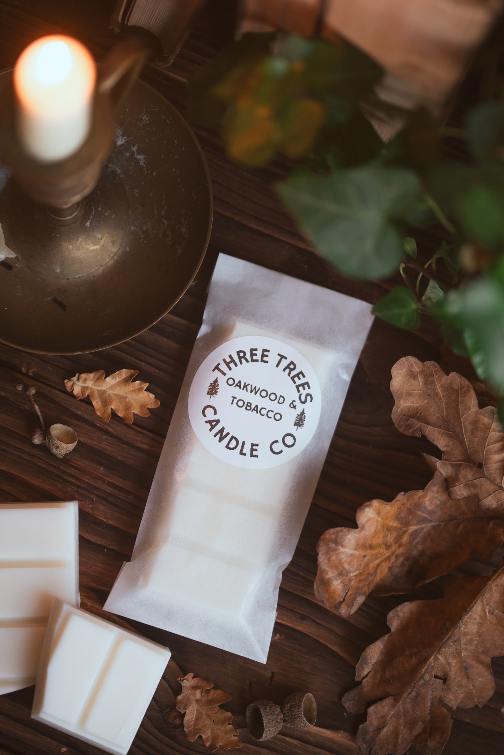 oakwood and tobacco scented wax melt bar on autumn table
