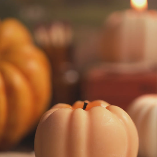 Lighting orange pumpkin shaped candle 