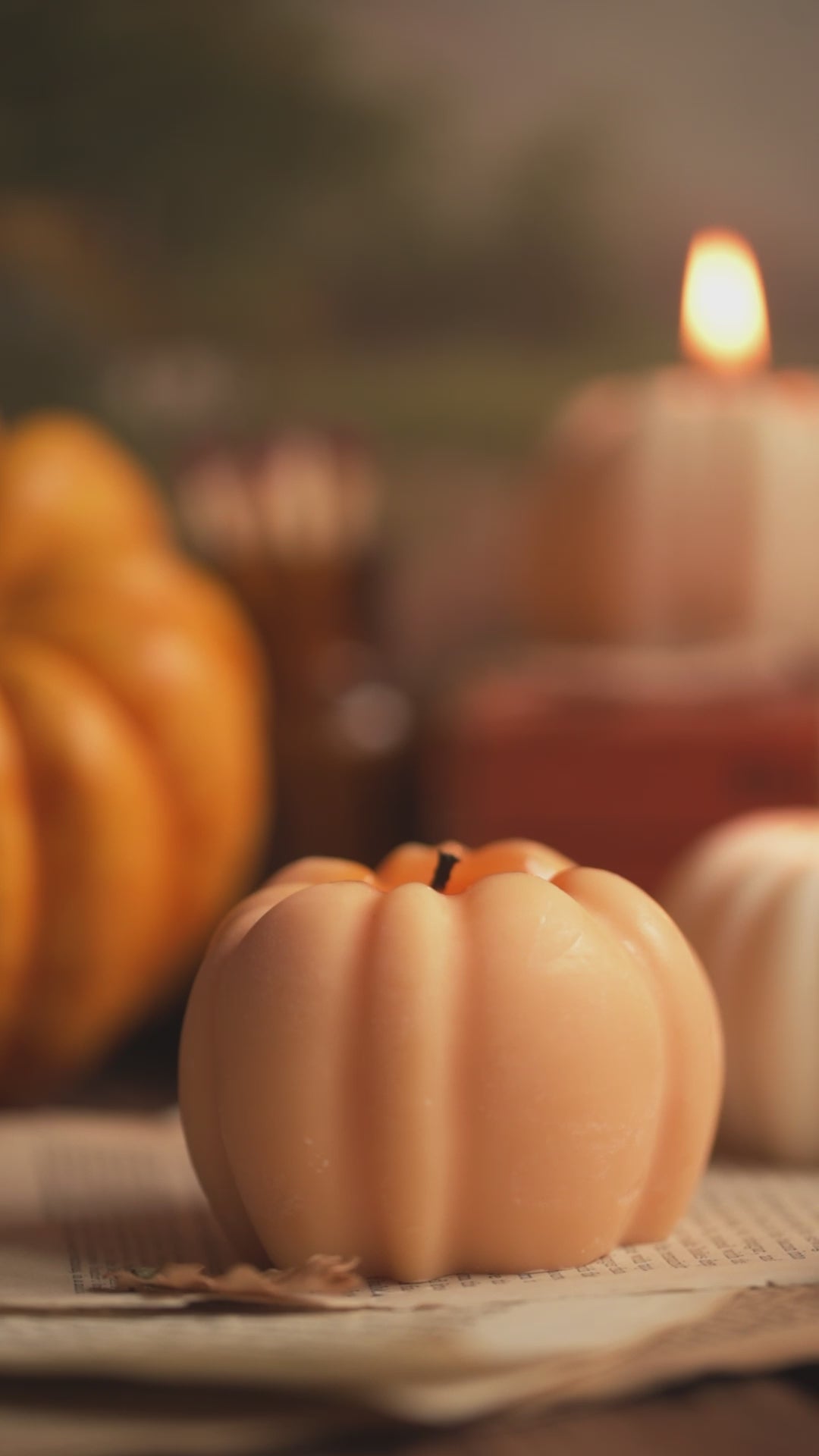 Lighting orange pumpkin shaped candle 
