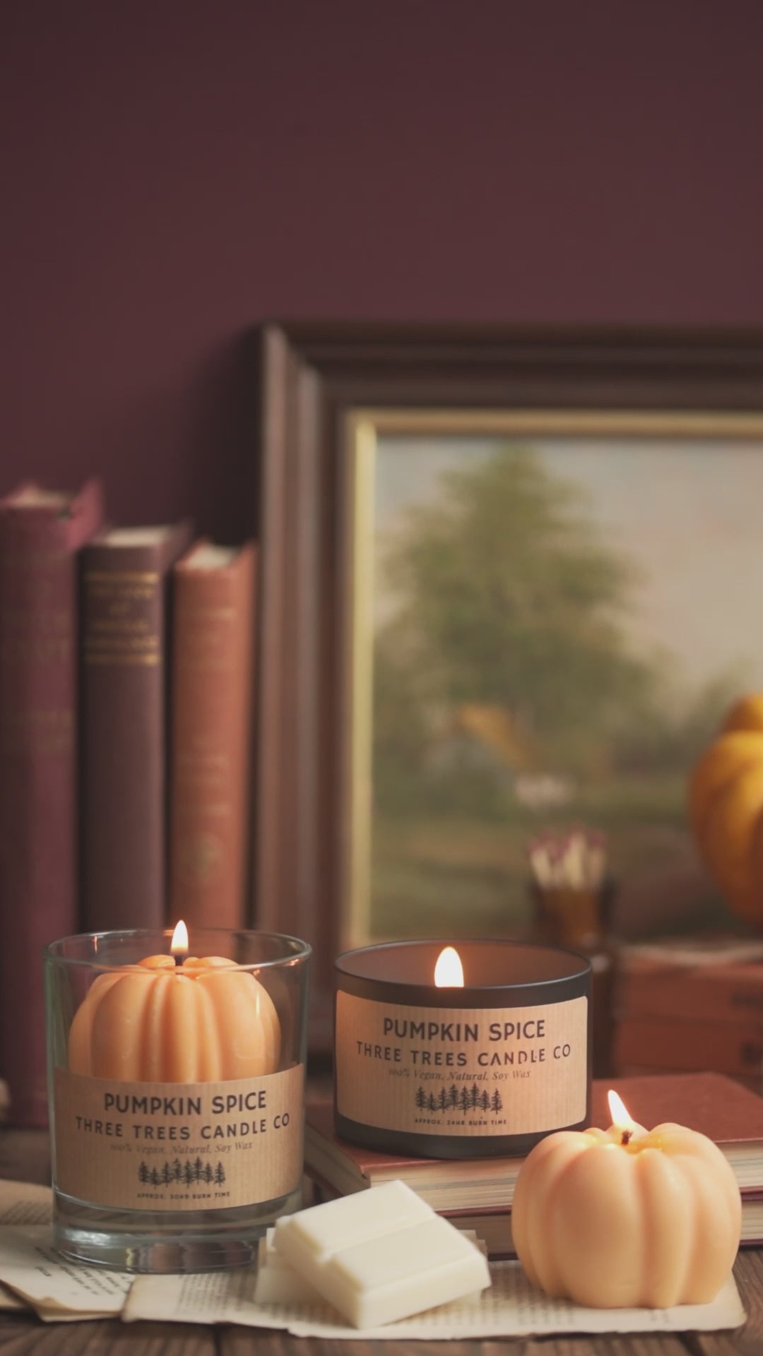 Pumpkin spice candles and wax melts on autumn table 