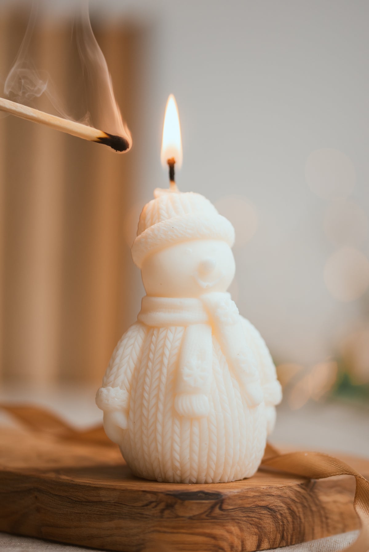 Snowman-shaped soy wax candle with festive winter design