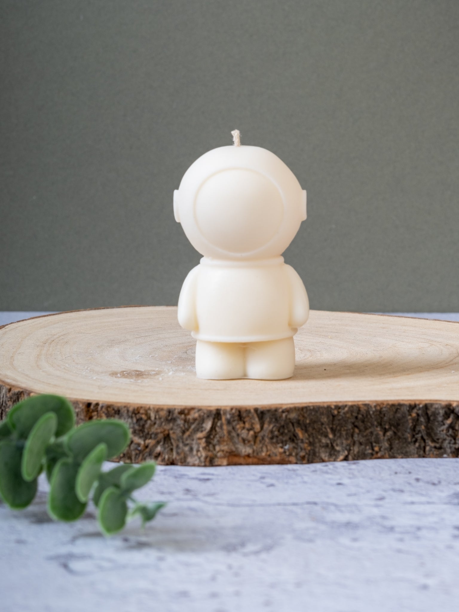 Spaceman candle styled on table with quirky home decor