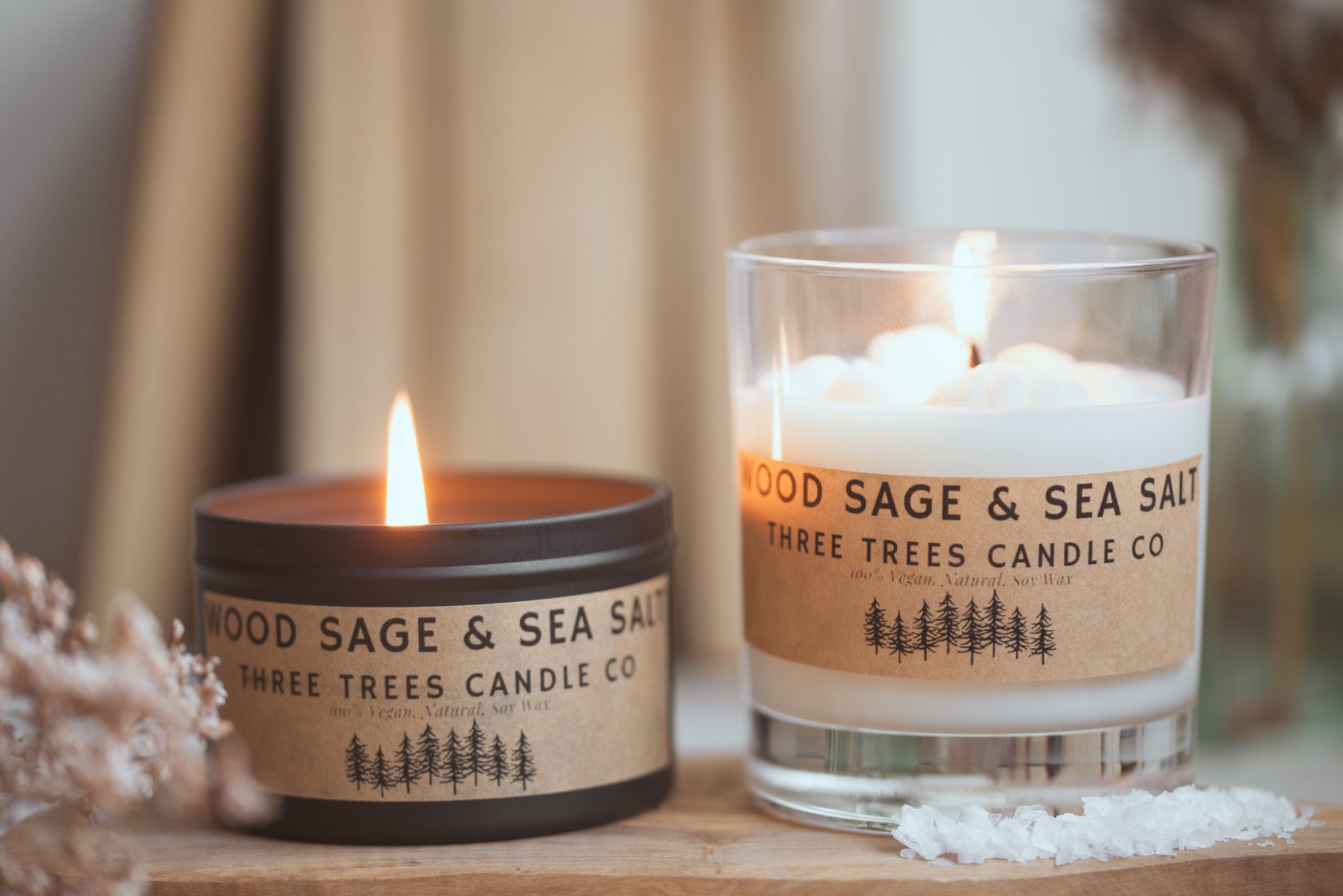 wood sage and sea salt scented candles on table decor 