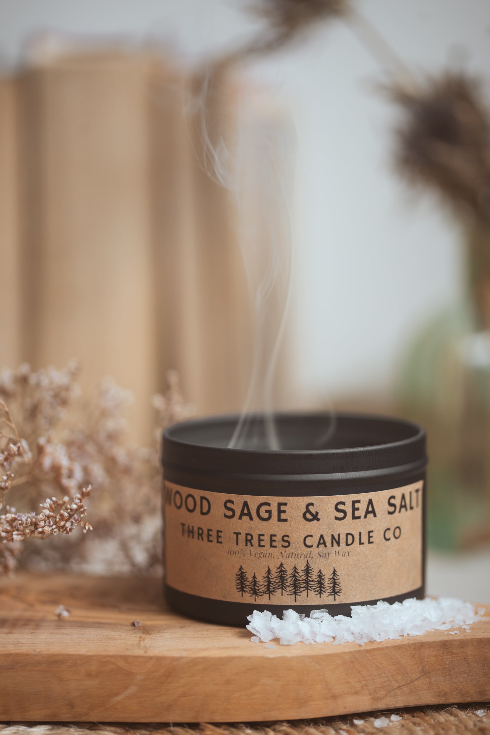 Wood Sage & Sea Salt candle styled on table with coastal decor