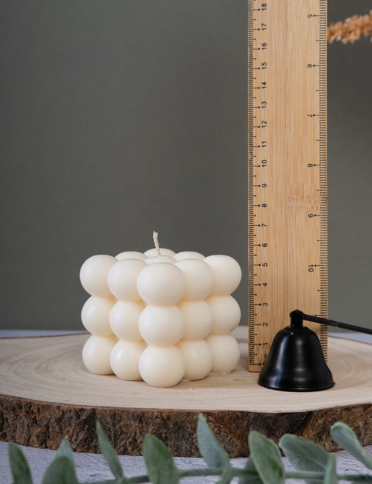 Close-up of bubble cube candle showing height