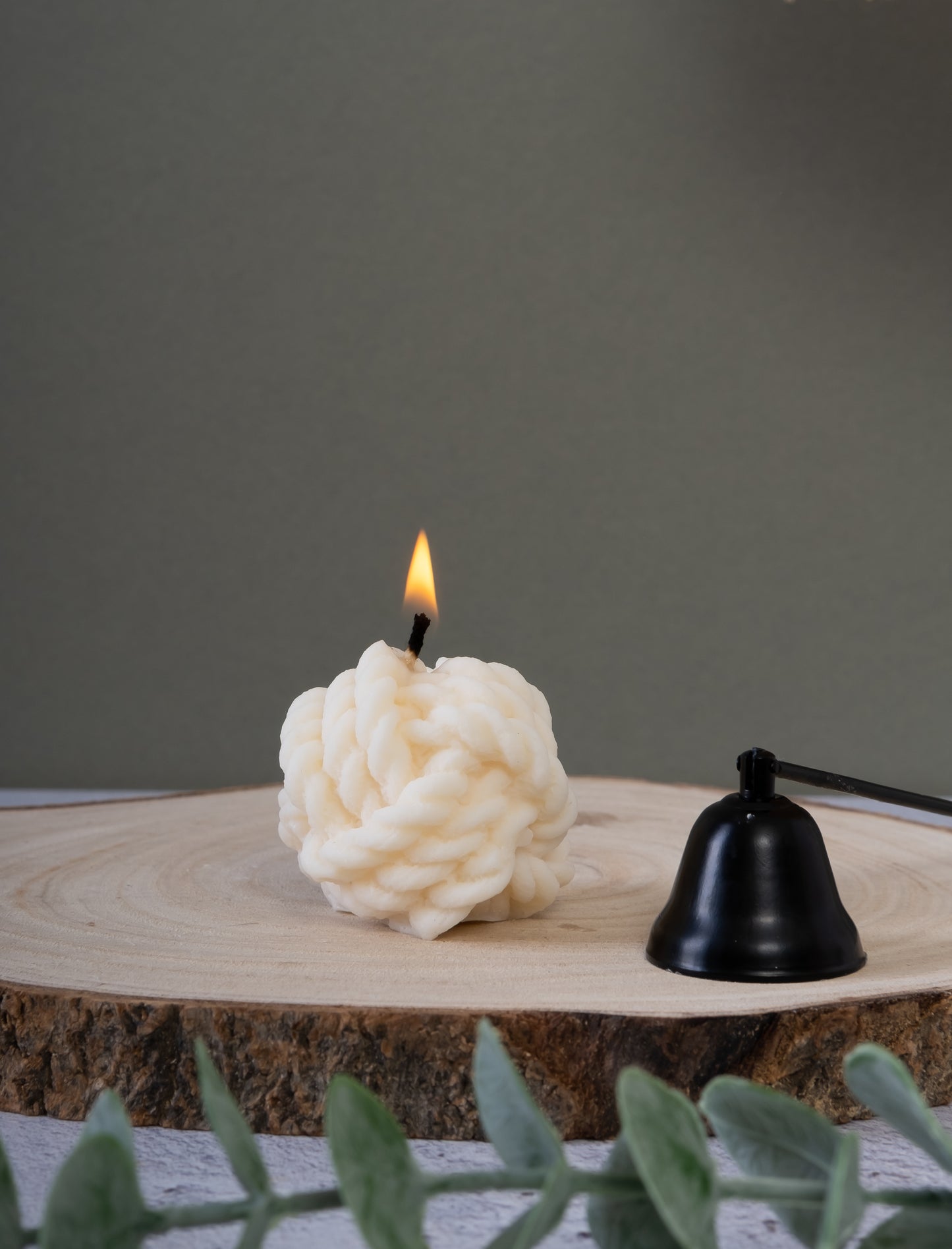 Knot-shaped candle styled on table as modern home decor