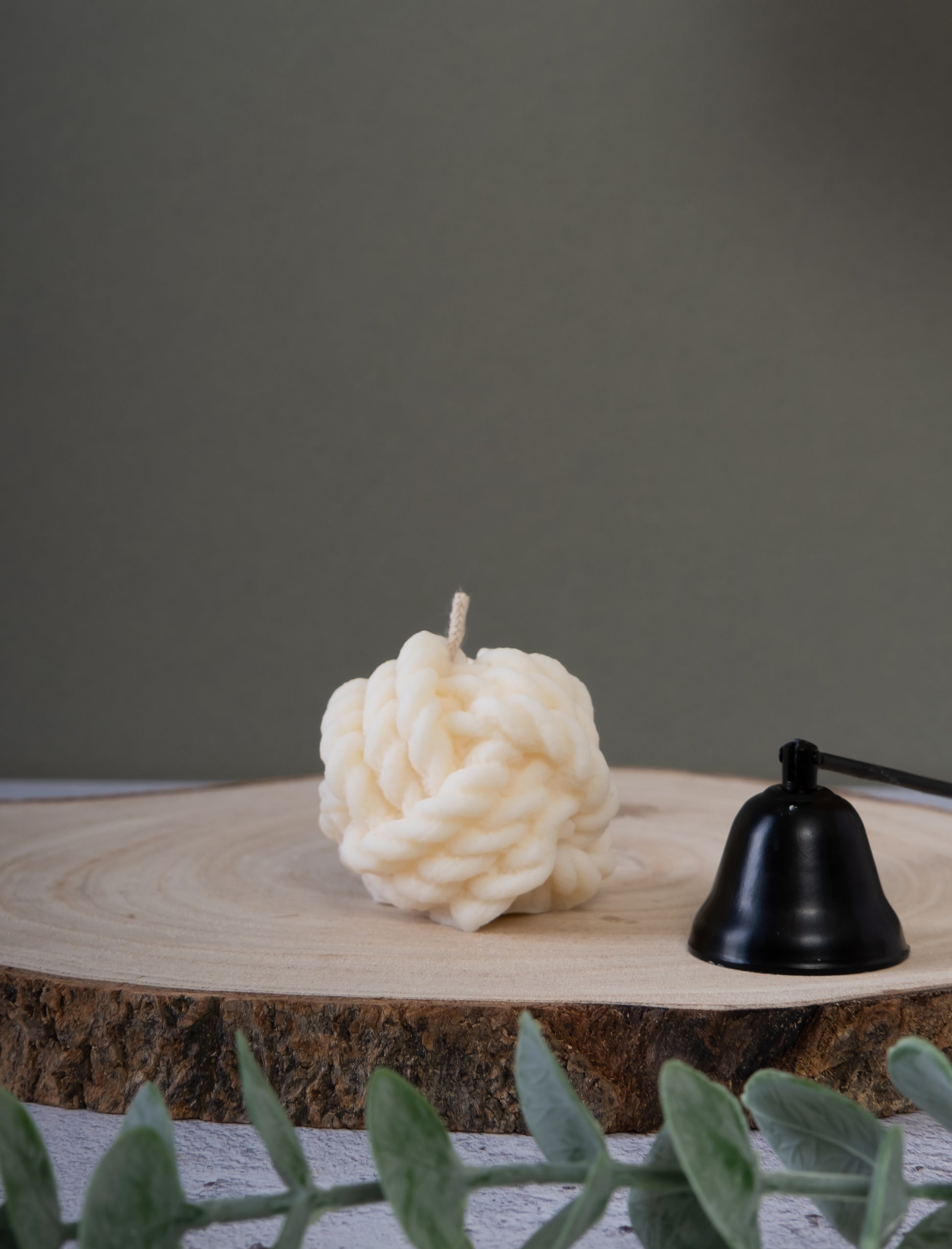 Knot-shaped candle styled on table as modern home decor